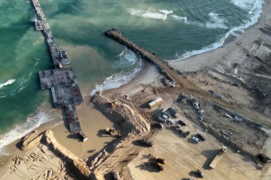 This image grab from a handout video released by the Israeli army shows humanitarian aid entering the Gaza Strip via a temporary, floating pier constructed by the United States