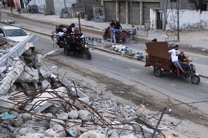 Palestinians transport their belongings as they flee Rafah in the southern Gaza Strip amid the ongoing conflict between Israel and the Hamas militant group