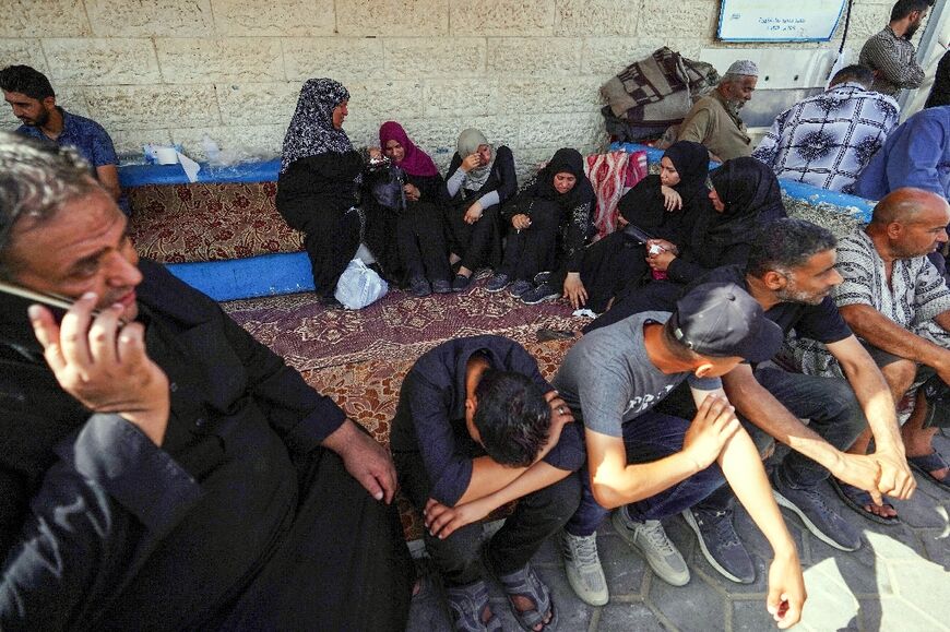 Palestinians mourn outside Gaza's Al-Aqsa Martyrs Hospital in Deir al-Balah following Israeli bombardment overnight on May 23, 2024