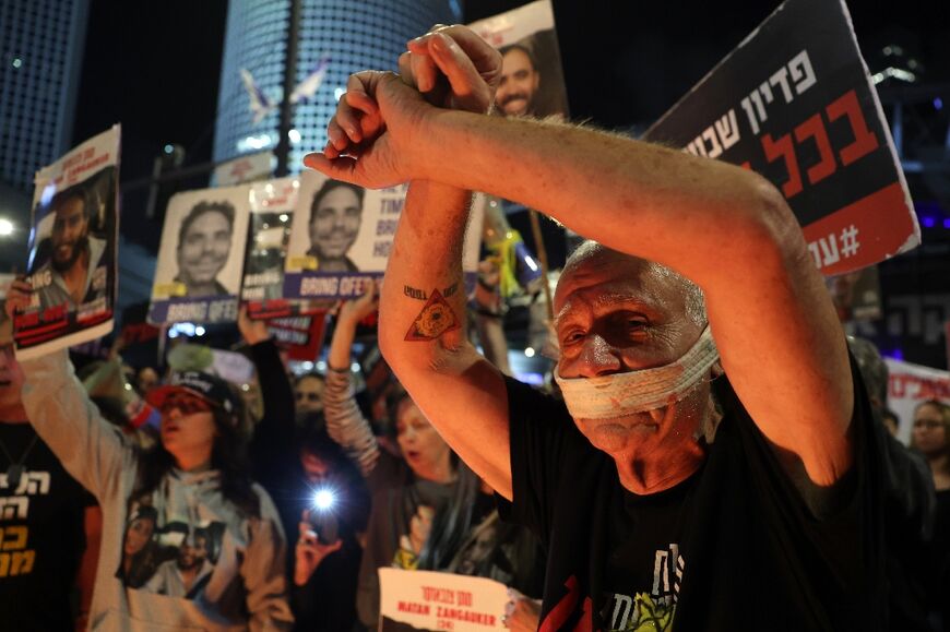 Relatives and supporters of hostages seized by Gaza militants during the October 7 attacks rally in Tel Aviv for their release