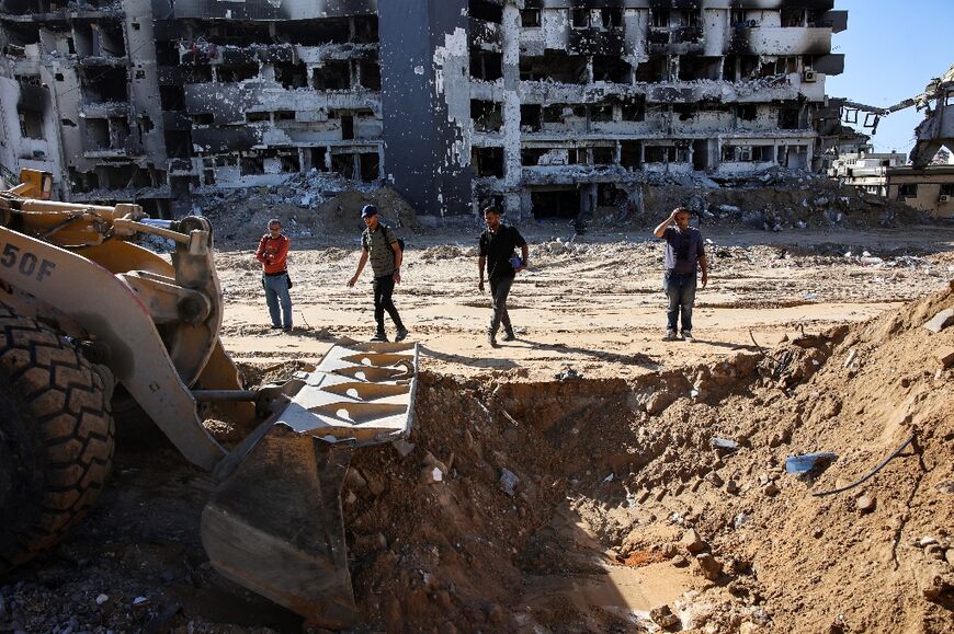 A bulldozer assists in the search for bodies at the Al-Shifa medical complex in Gaza City, where a medical official and Hamas authorities said an additional 49 corpses were uncovered 