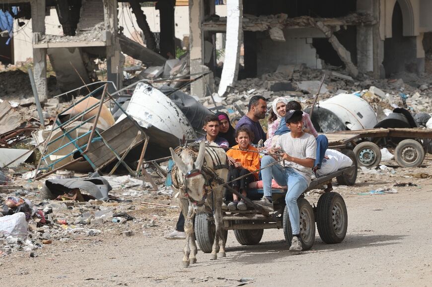 Displaced Palestinians evacuate from the Tal al-Zaatar camp for Palestinian refugees in the northern Gaza Strip