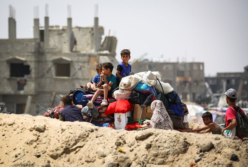 Palestinians transporting their belongings arrive in Khan Yunis in the southern Gaza Strip to seek shelter 