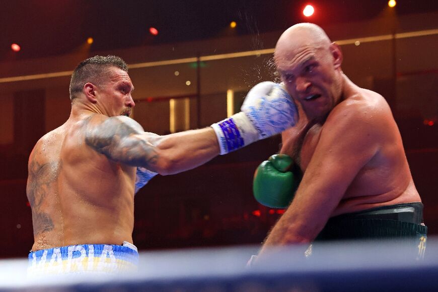 Ukraine's Oleksandr Usyk (L) on the way to a split decision victory over Britain's Tyson Fury for the undisputed heavyweight world title