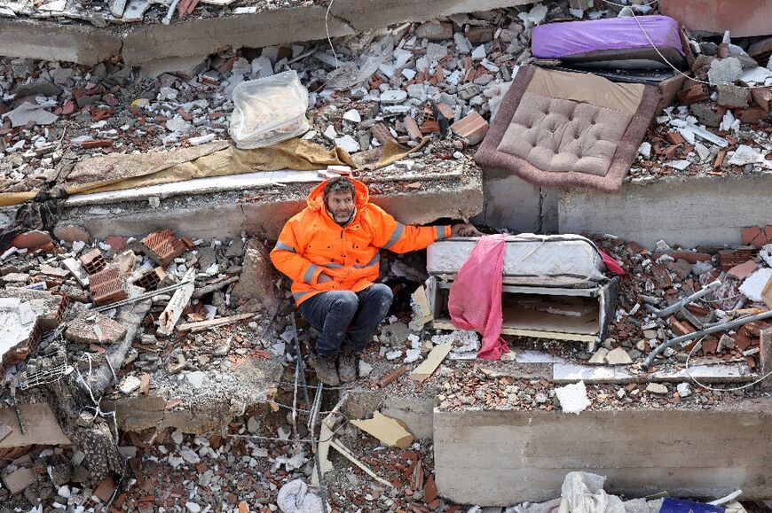 In Altan's nominated photo, a father is seen clutching the hand of his deceased daughter, her arm barely protruding from the rubble.