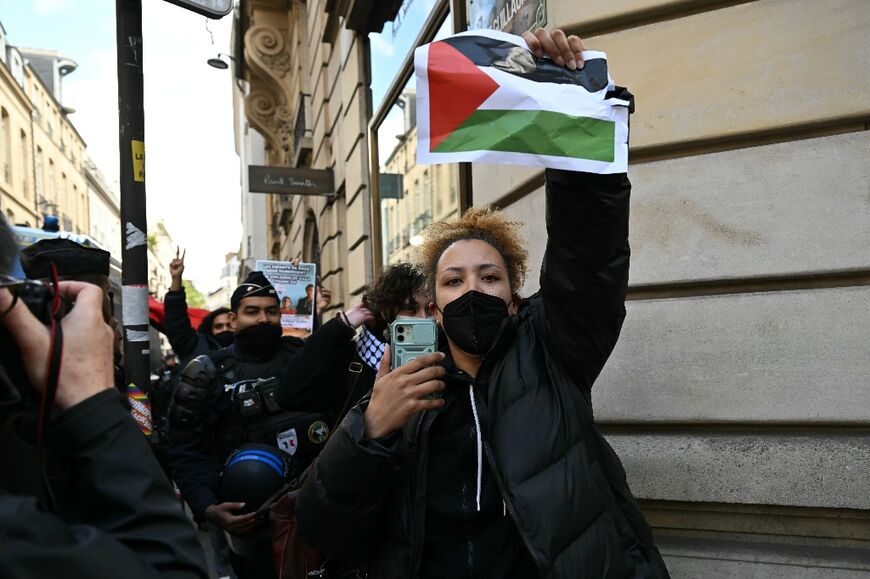 Some demonstrators held up Palestinian flags as they were led away