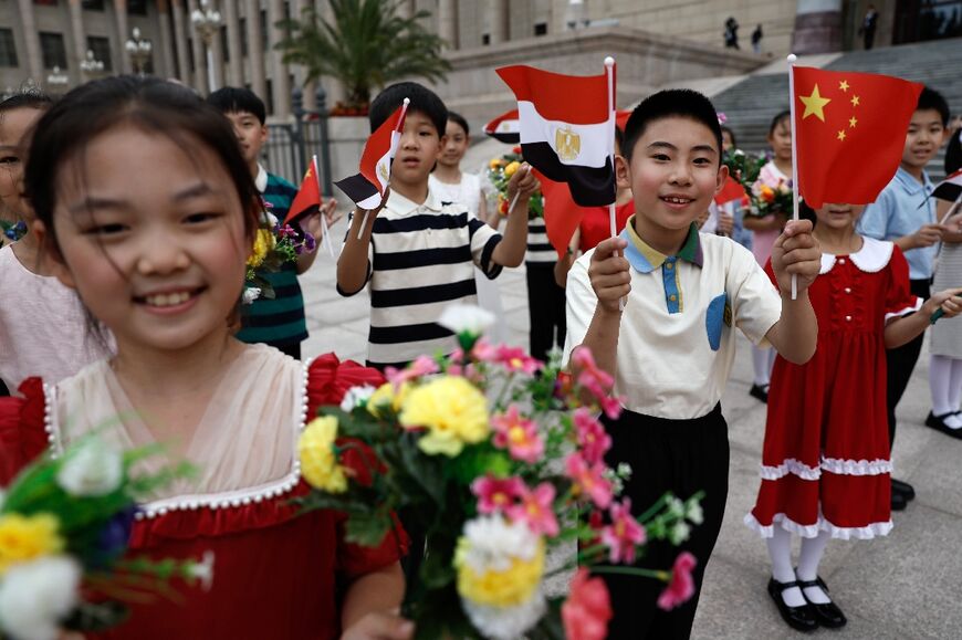 Children cheer as they rehearse for a welcome ceremony for Egyptian President Abdel Fattah al-Sisi at the Great Hall of the People in Beijing