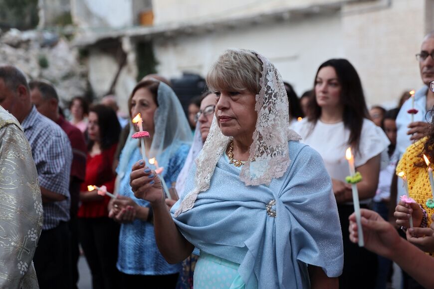 Palestinian Orthodox Christians attend Easter mass outside the church of Saint Porphyrius in Gaza City