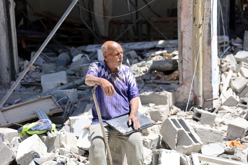 A Palestinian man in front of a destroyed building in northn Gaza's Jabalia refugee camp