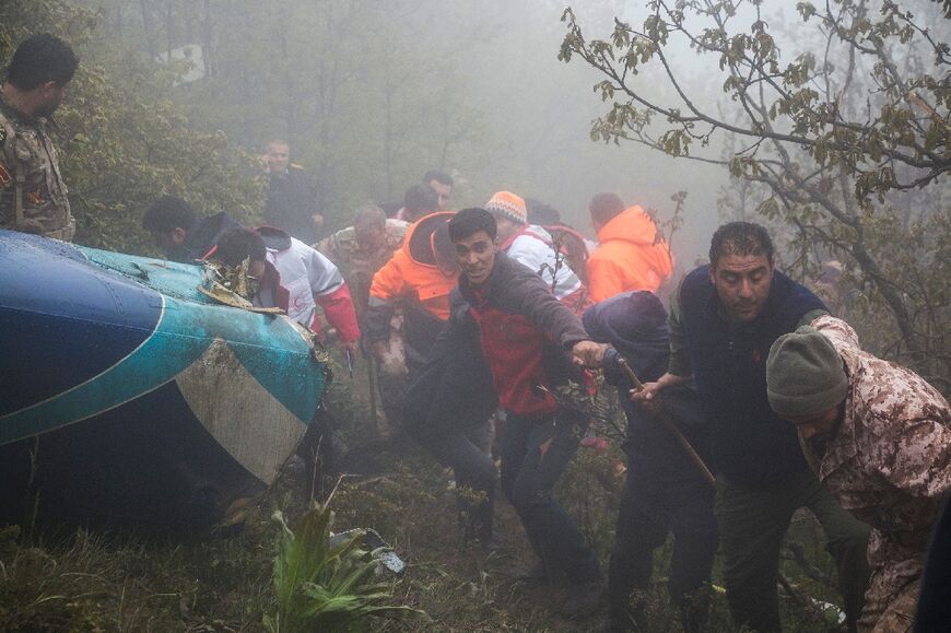 Rescue team members work at the crash site of the helicopter that was carrying Iranian President Ebrahim Raisi in Varzaghan, northwestern Iran, on May 20, 2024