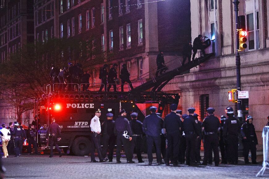 NYPD officers in riot gear break into a building at Columbia University, where pro-Palestinian students are barricaded inside a building and have set up an encampment, in New York City 