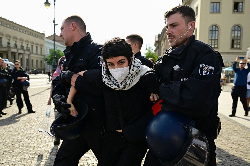 A demonstrator is carried away by police as people staged a pro-Gaza sit-in in solidarity with the Palestinian people in front of Berlin's Humboldt University, on May 3, 2024