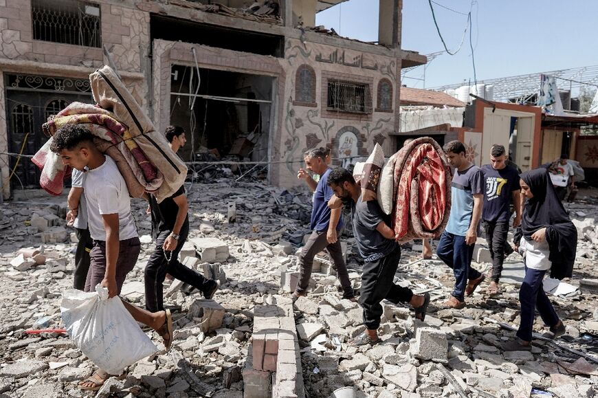 Palestinians evacuate with their belongings following an Israeli operation in Gaza's Nuseirat refugee camp