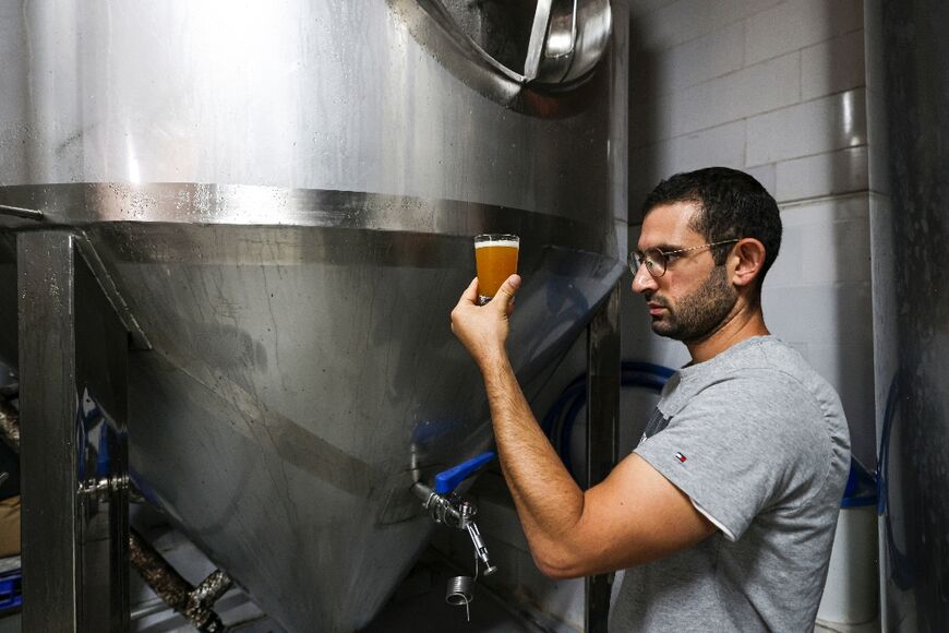 Kanaan Khoury, the son of the brewery founder, checks the beer at the brewery in the village of Taybeh, which means 'it's delicious' in Arabic 