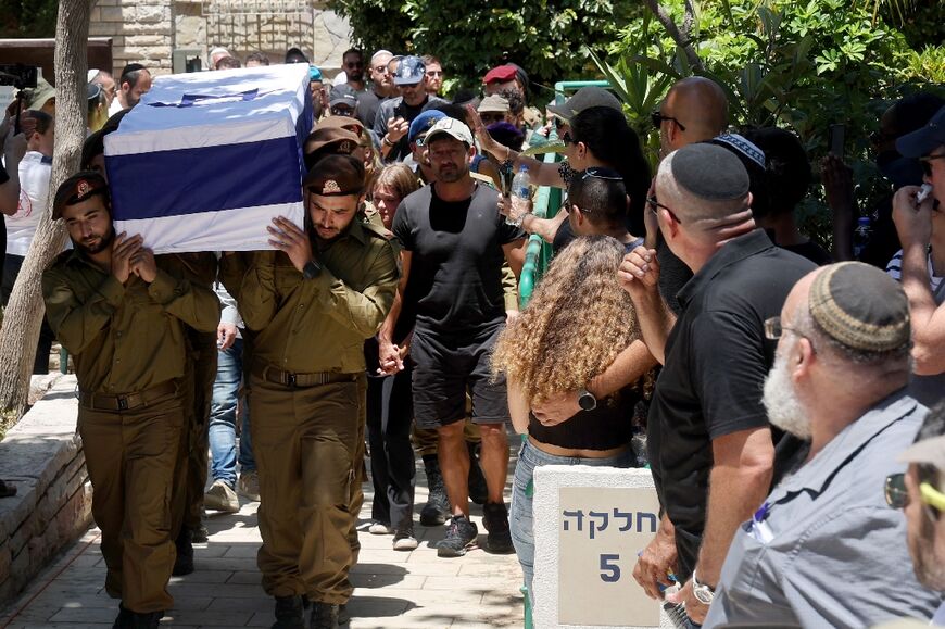 Israeli soldiers carry the coffin of a colleague killed on Thursday in Gaza, where at least 312 Israeli soldiers have been killed