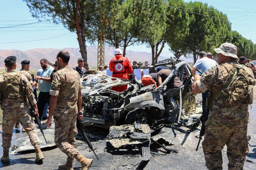 Security forces and emergency workers at the scene of the air strike