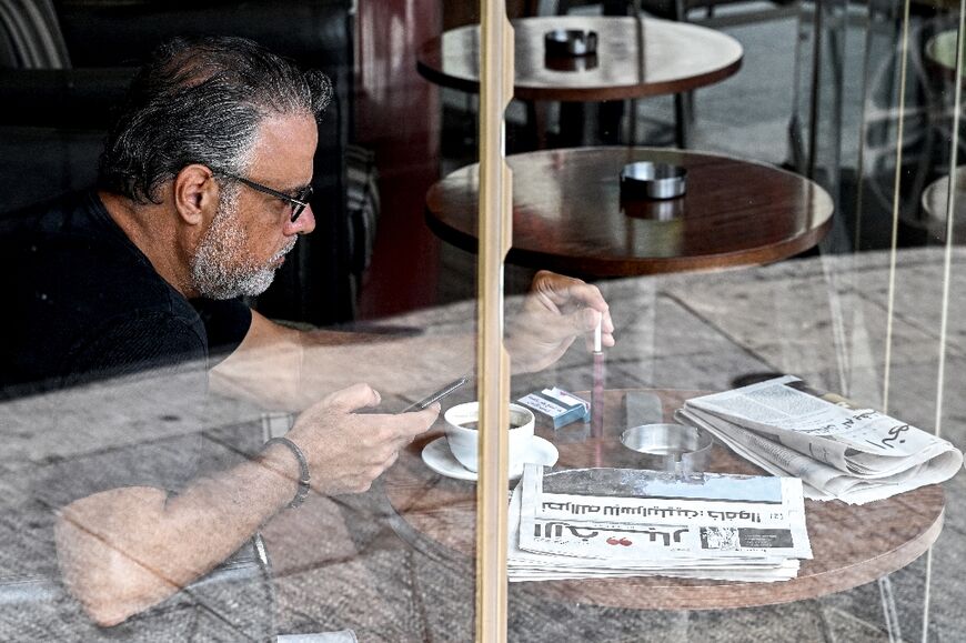 A copy of Lebanese newspaper Al-Akhbar sits at a cafe on Beirut's Hamra Street with a headline in Arabic saying: "Nasrallah to Israelis: 'Fear!'" 