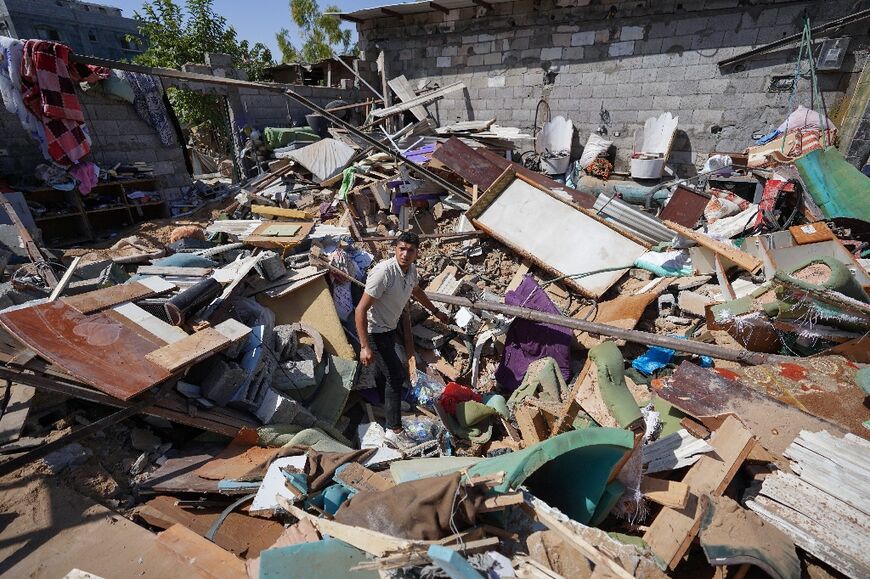 A Palestinian man searches the rubble of a family home following overnight Israeli strikes in Gaza's Nuseirat refugee camp