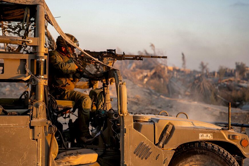 A picture released by the Israeli army shows a soldier manning a machine gun turret atop vehicle operating in the Gaza Strip 