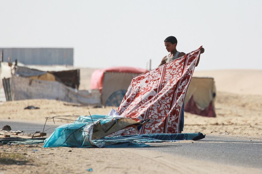 Palestinian families pack to leave Rafah for Khan Yunis, southern Gaza -- the UN says more than one million people have been forced from Rafah since early May 2024 when an Israeli ground operation began there