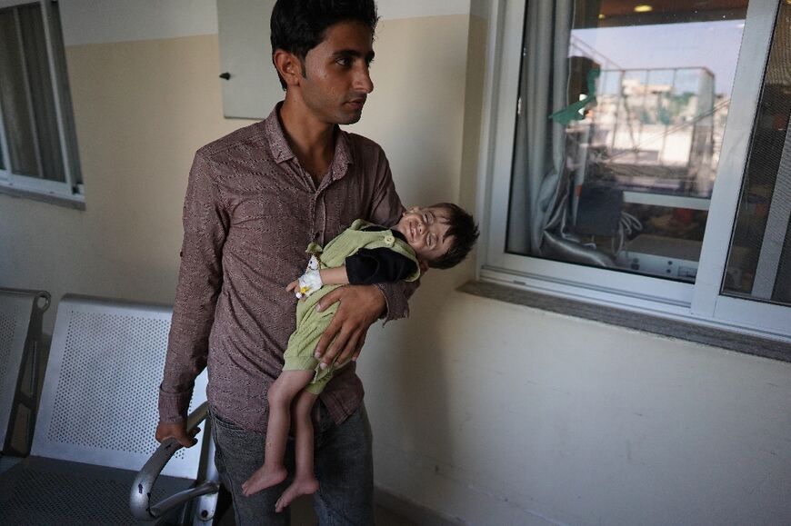 Palestinian children suffering malnutrition or chronic diseases wait with family members in the southern Gaza Strip after they reportedly received permission from the Israeli army to leave the besieged Palestinian territory 