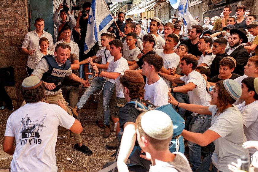 Israeli right-wing activists scuffle with Palestinian freelance journalist Saif Kwasmi on June 5, 2024 during the so-called Jerusalem Day flag march