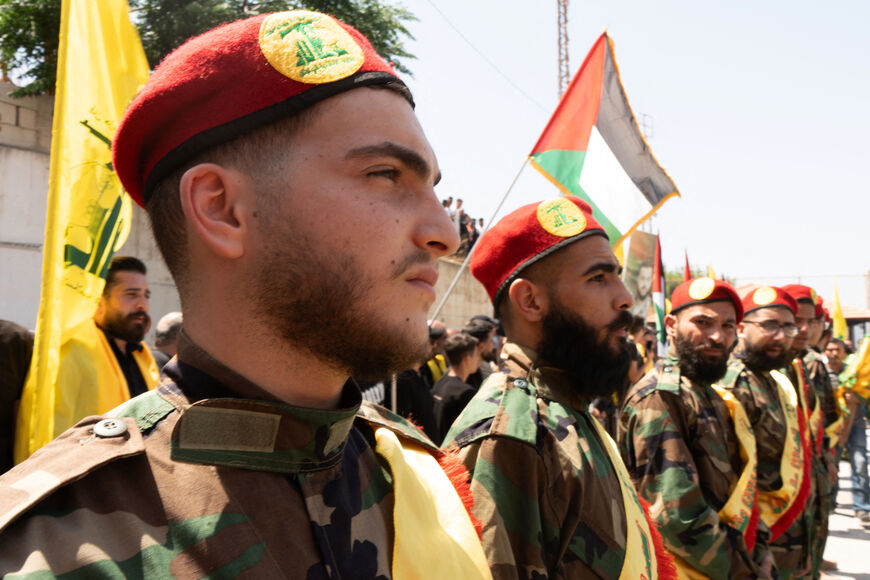 Commrades attend the funeral of killed Hezbollah fighter Wehbi Mohammed Ibrahim, in the village of Kfar Kila in southern Lebanon on June 20, 2024, amid continuing tensions on the Lebanese-Israeli border. Hezbollah said it fired "dozens" of rockets into northern Israel on July 20, 2024, in retaliation for a deadly strike in south Lebanon, a day after a fiery speech from the group's leader. (Photo by Hassan FNEICH / AFP) (Photo by HASSAN FNEICH/AFP via Getty Images)