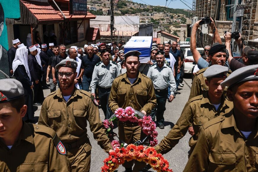 Mourners at the northern Israel funeral of one of eight soldiers killed in a blast near Gaza's Rafah