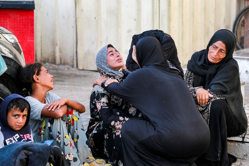 Relatives at Al-Aqsa Martyrs Hospital in Deir al-Balah, central Gaza, mourn Eyad Hegazi, 10, who died suffering malnutrition