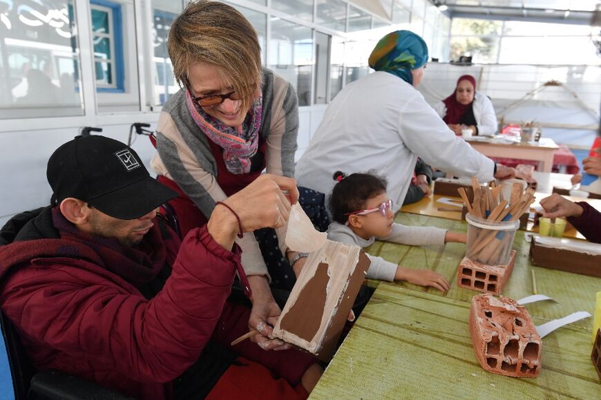 Swiss artist Anne Francey instructs a group of young people with disabilities during a collaborative art session