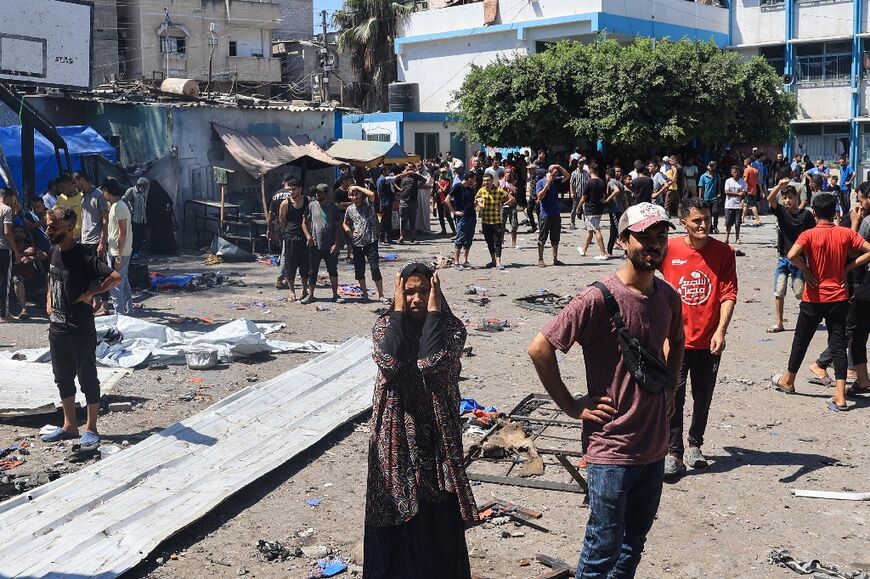 A woman reacts after the strike on the Al-Razi School in Gaza's Nuseirat refugee camp