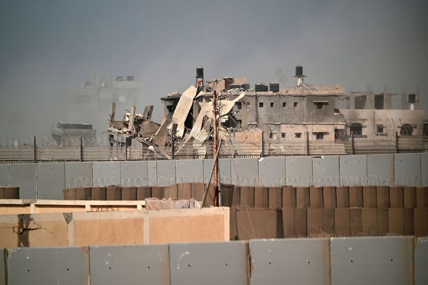 A damaged building in southern Gaza is seen from the Egyptian side of the border