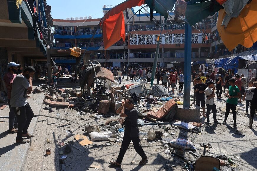 Palestinians survey the damage following Israeli bombardment of a UN-run school in Gaza's Nuseirat refugee camp