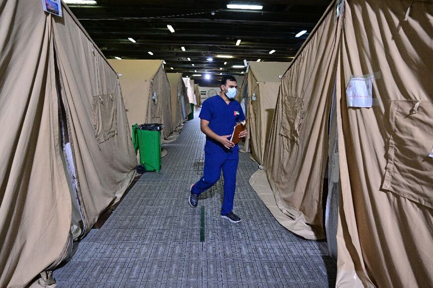 The floating facility's rows of tents below deck hold about 100 patients at a time