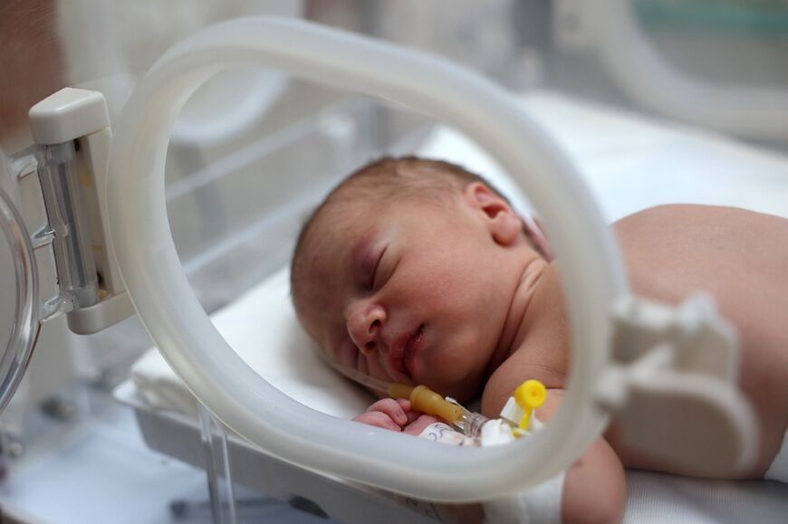 A baby boy, who was delivered by Cesarean section after his pregnant mother died from injuries sustained during an Israeli strike on Nusseirat in the central Gaza Strip, lies in an incubator at the Al-Aqsa Martyr's hospital in Deir el-Balah