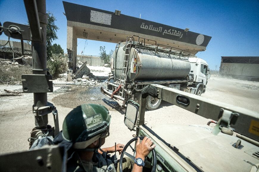 Israeli soldiers drive on the Palestinian side of Kerem Shalom crossing on July 3, 2024, during a military-organised visit for journalists