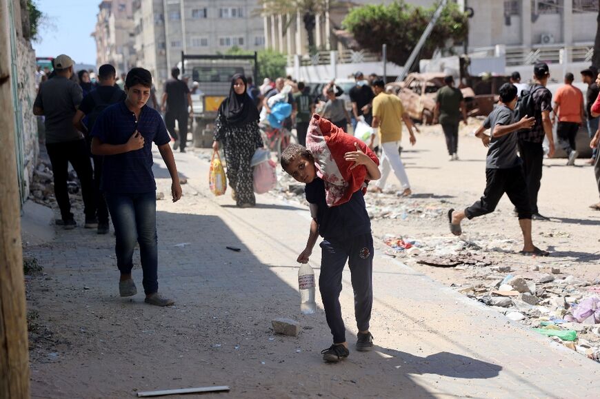 Palestinians flee an area of Gaza City following an evacuation order issued by the Israeli military