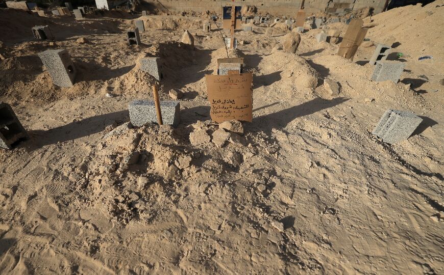 Mounds of freshly dug soil are reminders of recent burials at the Deir el-Balah cemetery, in the central Gaza Strip