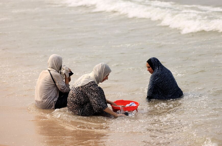 Palestinian women wash their clothes using sea water due to the lack of fresh water and electricity