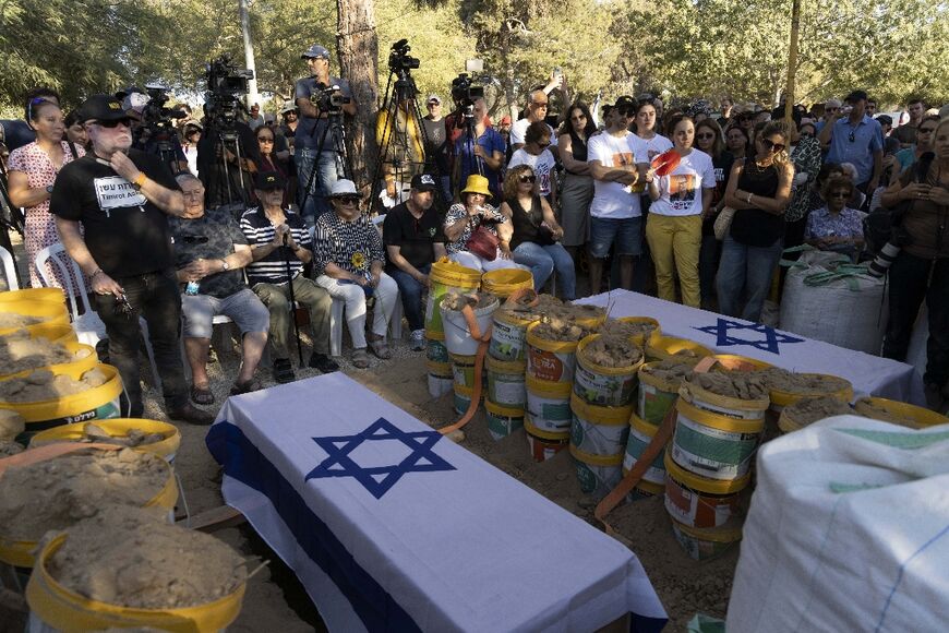 Relatives and friends attend the funeral of Avraham Munder at kibbutz Nir Oz in southern Israel