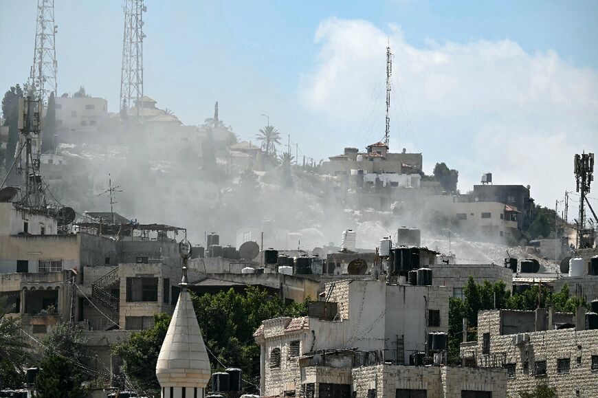 Smoke rises above buildings during an Israeli army raid in Jenin on August 31, 2024