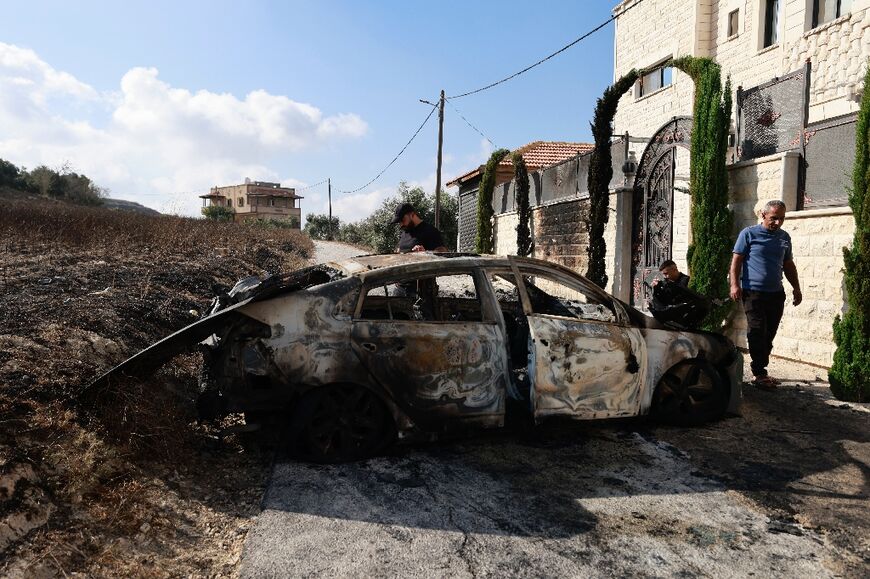 Palestinians inspect the damage from a deadly attack by armed Jewish settlers on the West Bank village of Jit