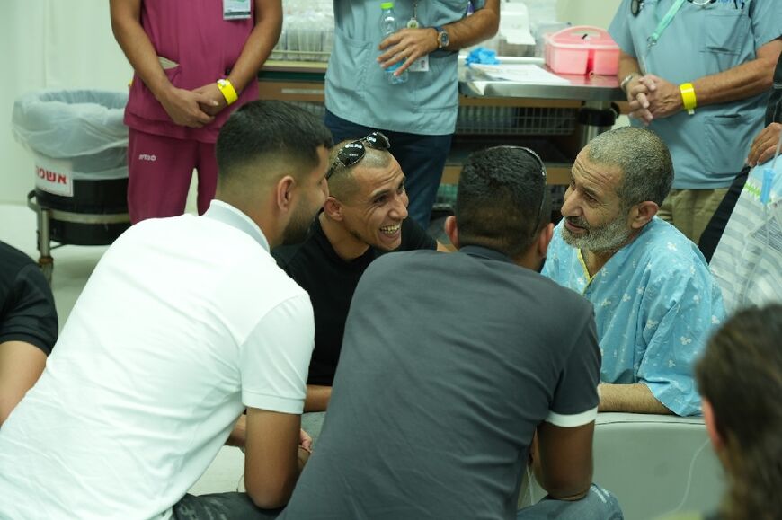 A handout image made available by the Israeli prime minister's office shows freed hostage Kaid Farhan Alkadi reuniting with family at hospital