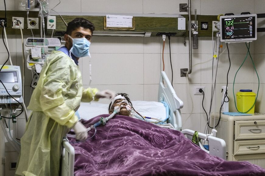 A medic treats a man wounded in the air strike