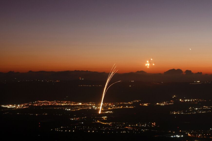 Rockets fired from southern Lebanon are intercepted by Israeli air defences over the Upper Galilee region in northern Israel