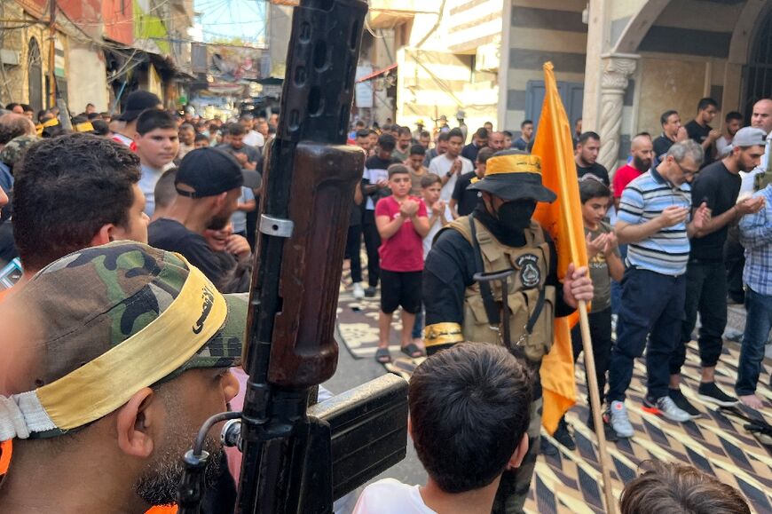 Palestinian fighters and mourners at the funeral of Khalil Maqdah, in Lebanon's Ain al-Helweh refugee camp