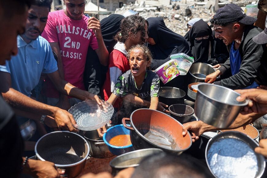 A child at a food distribution point in the Bureij camp for Palestinian refugees in central Gaza -- Gazans struggle to find food and other essentials in the besieged territory