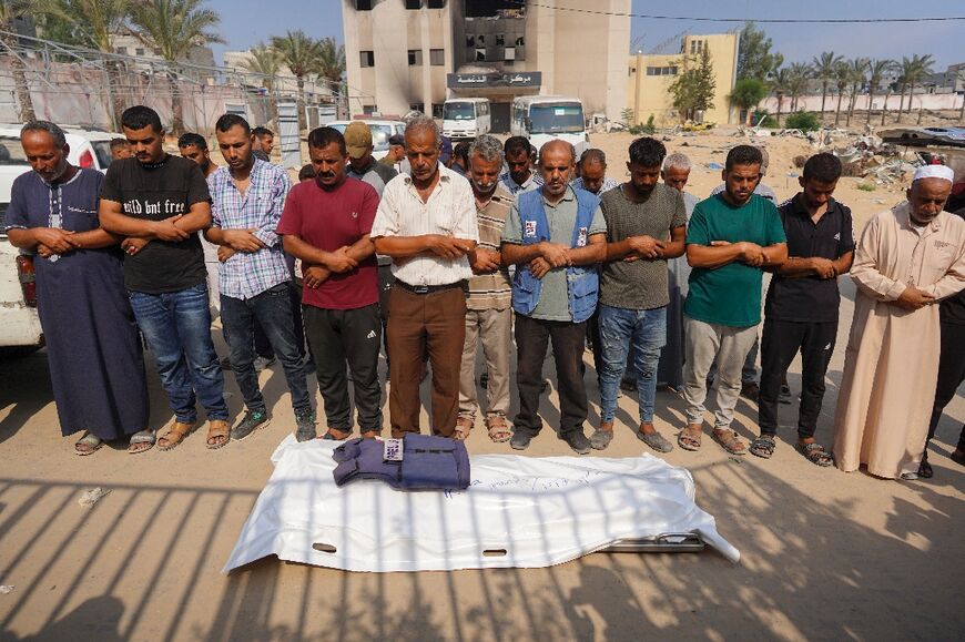 Relatives and friends pray over the body of photojournalist Ibrahim Muhareb, in southern Gaza's Khan Yunis