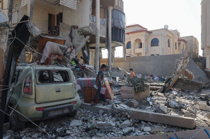 Palestinians inspect the damaged following overnight Israeli bombardment at the Nuseirat refugee camp in the central Gaza Strip