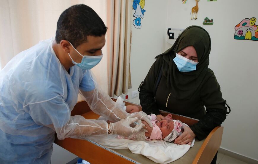 An UNRWA employee on September 9, 2020 provides polio and rotavirus vaccines for children at a clinic in Bureij refugee camp, central Gaza